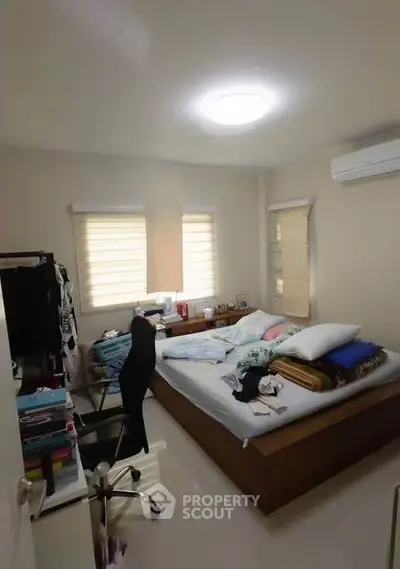 Cozy bedroom with modern decor and ample natural light