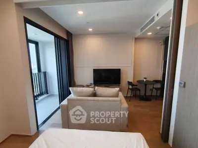 Modern living room with balcony access and stylish furniture in a contemporary apartment.