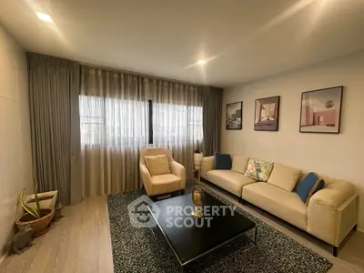Stylish living room with modern decor and cozy seating area, perfect for relaxation.
