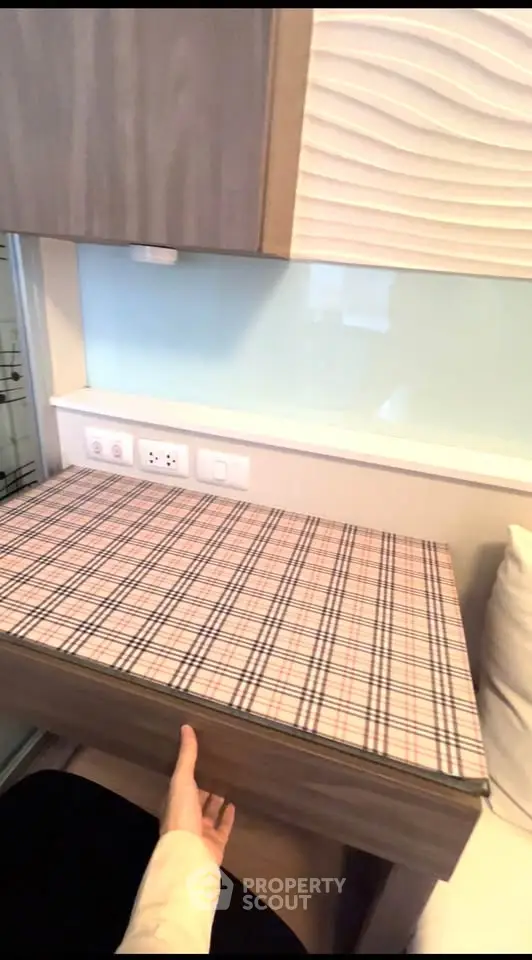 Compact and stylish kitchen area with modern cabinetry and sleek countertop design.
