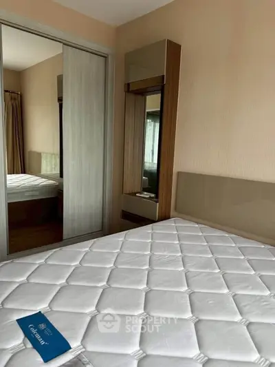 Spacious bedroom with modern design and large mirror closet