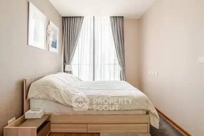 Bright and cozy bedroom with large window and elegant decor