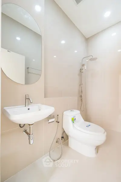 Modern bathroom with sleek fixtures and elegant design, featuring a shower and toilet.