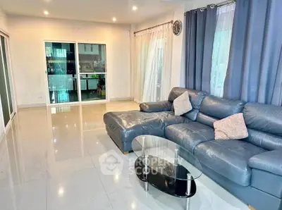 Spacious living room with modern leather sofa and glass coffee table
