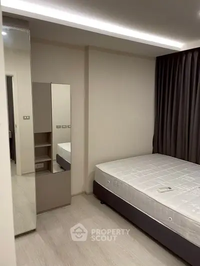 Modern minimalist bedroom with sleek design and ample natural light.