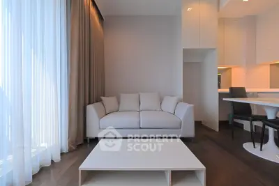 Modern living room with elegant sofa and dining area, featuring floor-to-ceiling windows and sleek design.