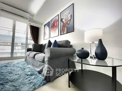 Stylish living room with modern decor, plush sofa, and elegant artwork, perfect for urban living.