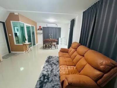 Spacious living room with modern decor and comfortable seating
