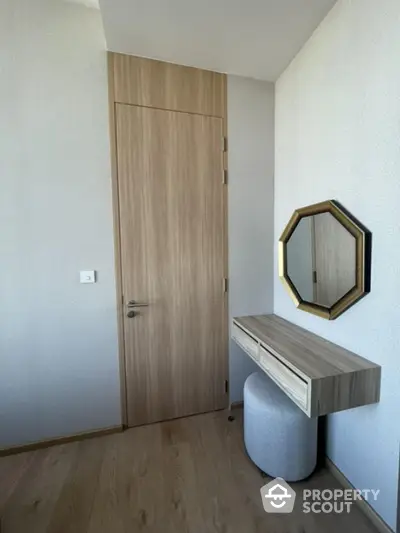 Modern minimalist room with wooden door and stylish wall-mounted vanity mirror