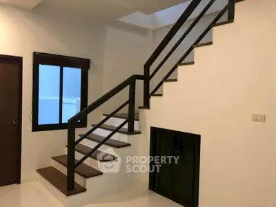 Modern interior staircase with sleek railing and minimalist design in a contemporary home.