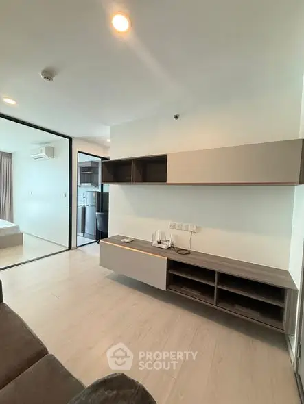 Modern living room with sleek storage and open layout in contemporary apartment