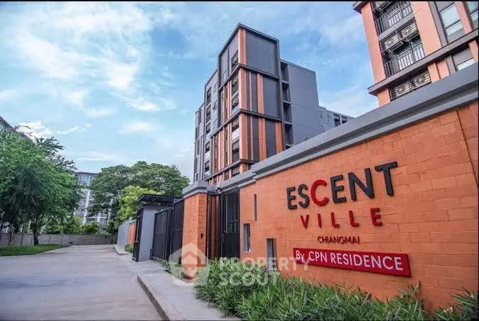Modern residential building exterior with lush greenery and clear blue sky in Chiang Mai.