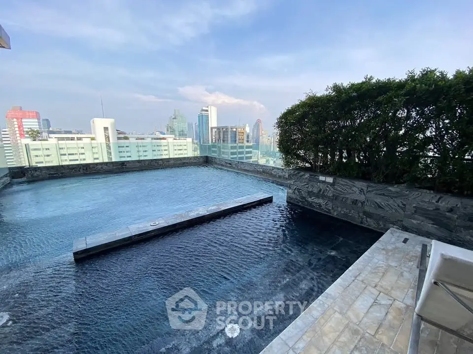 Luxurious rooftop pool with stunning city skyline view, perfect for relaxation and entertainment.