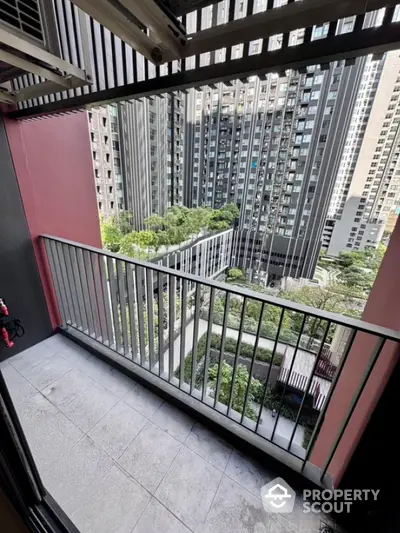 Modern urban balcony with cityscape view and greenery