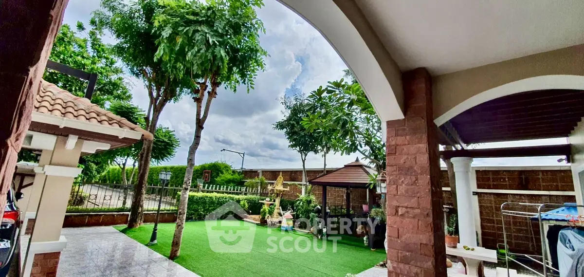 Charming outdoor garden with lush greenery and cozy gazebo, perfect for relaxation and entertaining.