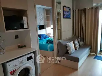 Modern apartment interior with cozy living area and washing machine