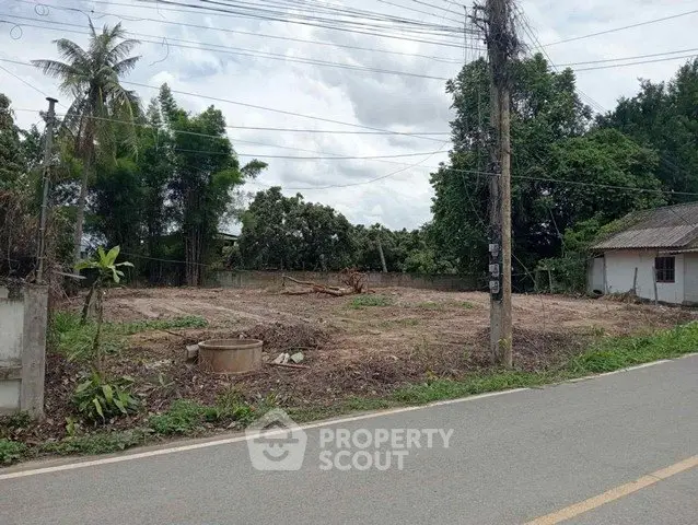 Vacant land plot with lush greenery, ideal for development in a serene neighborhood.