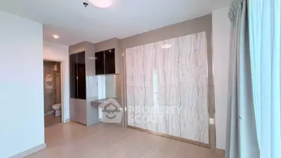 Modern bedroom with sleek design and ensuite bathroom in a contemporary apartment.