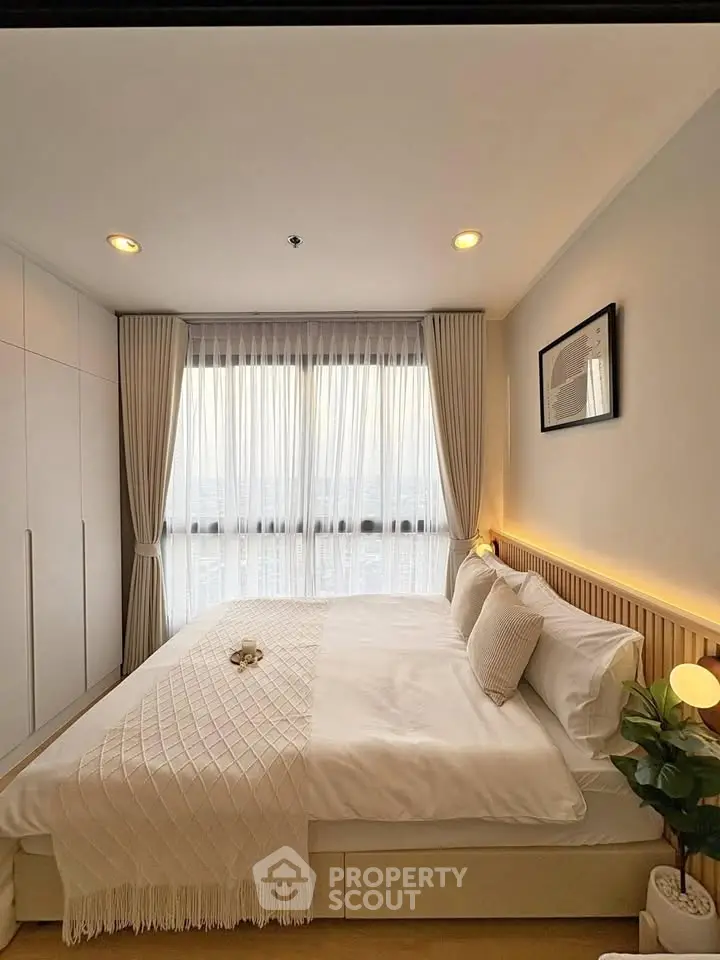 Cozy and elegant bedroom with large window and modern decor