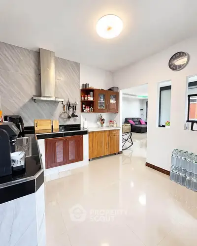 Spacious modern kitchen with sleek design and open layout, featuring stainless steel appliances and ample storage.