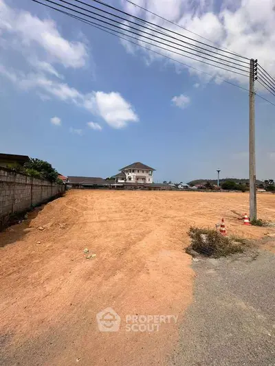 Expansive land plot with clear skies, ideal for development opportunities.