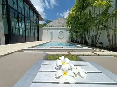 Luxurious villa with private pool and lush garden, perfect for tropical living.