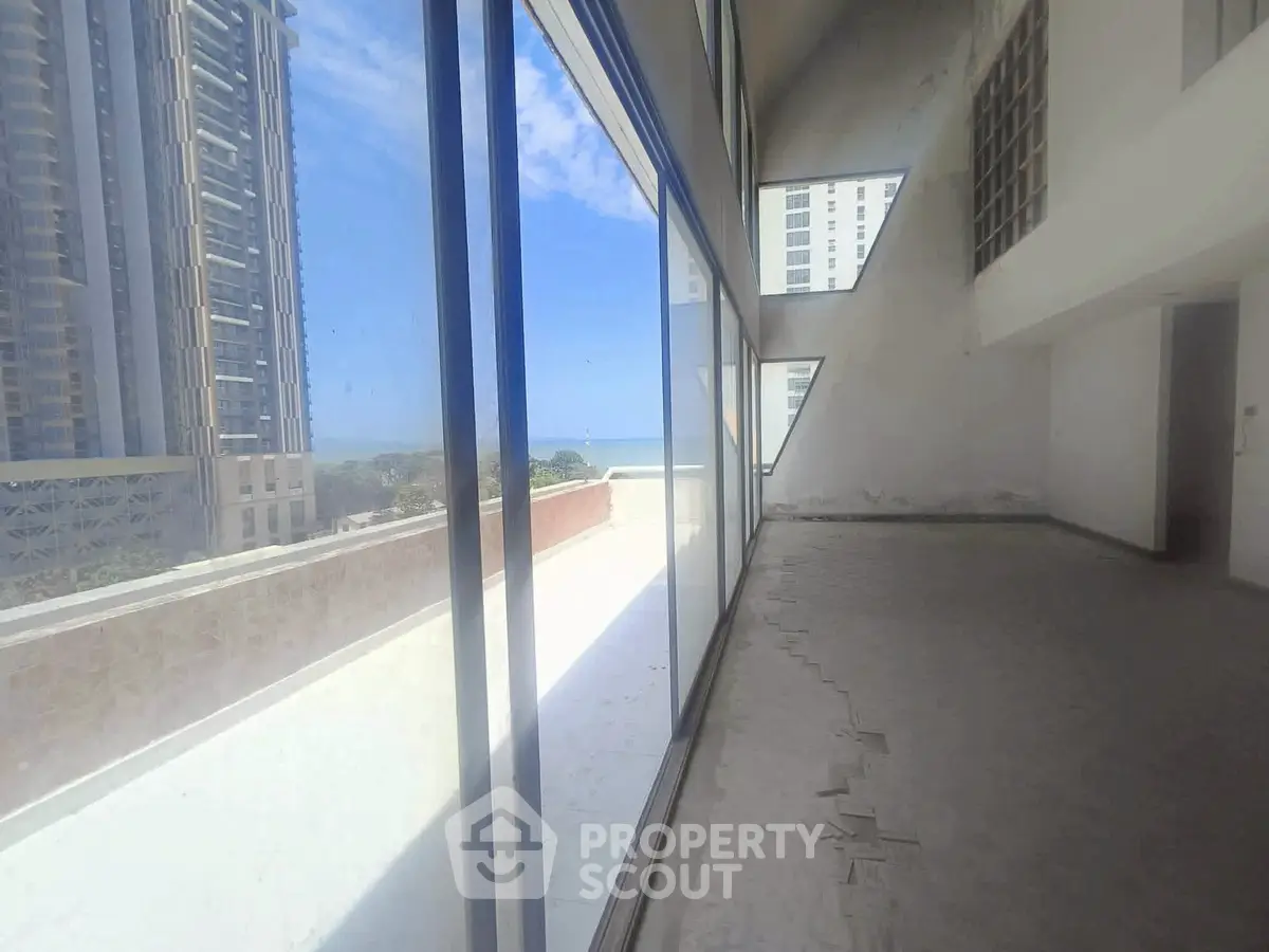 Spacious modern apartment with floor-to-ceiling windows and stunning city view