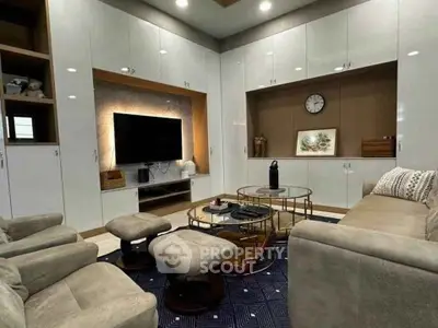 Modern living room with sleek furniture and built-in entertainment center