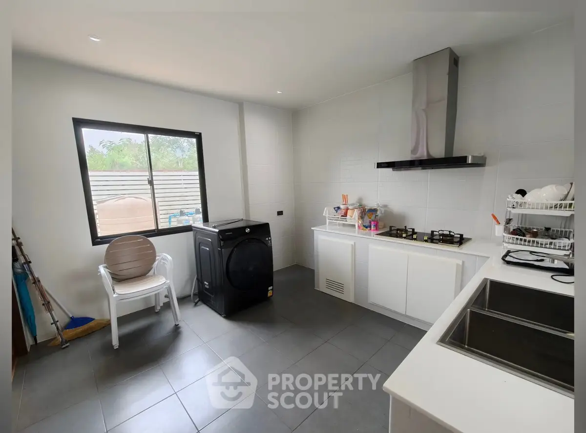 Modern kitchen with sleek appliances and ample natural light