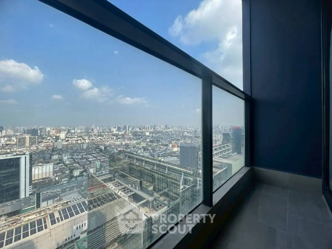 Stunning cityscape view from high-rise building with expansive glass windows.