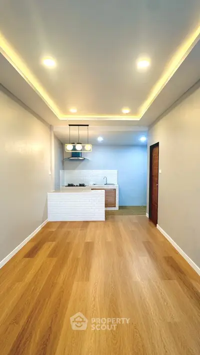 Modern kitchen with open layout and stylish lighting in a cozy apartment.