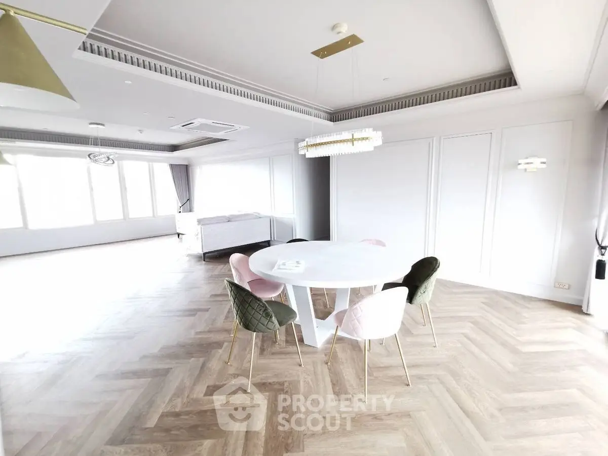 Spacious modern living room with elegant dining area and stylish parquet flooring.