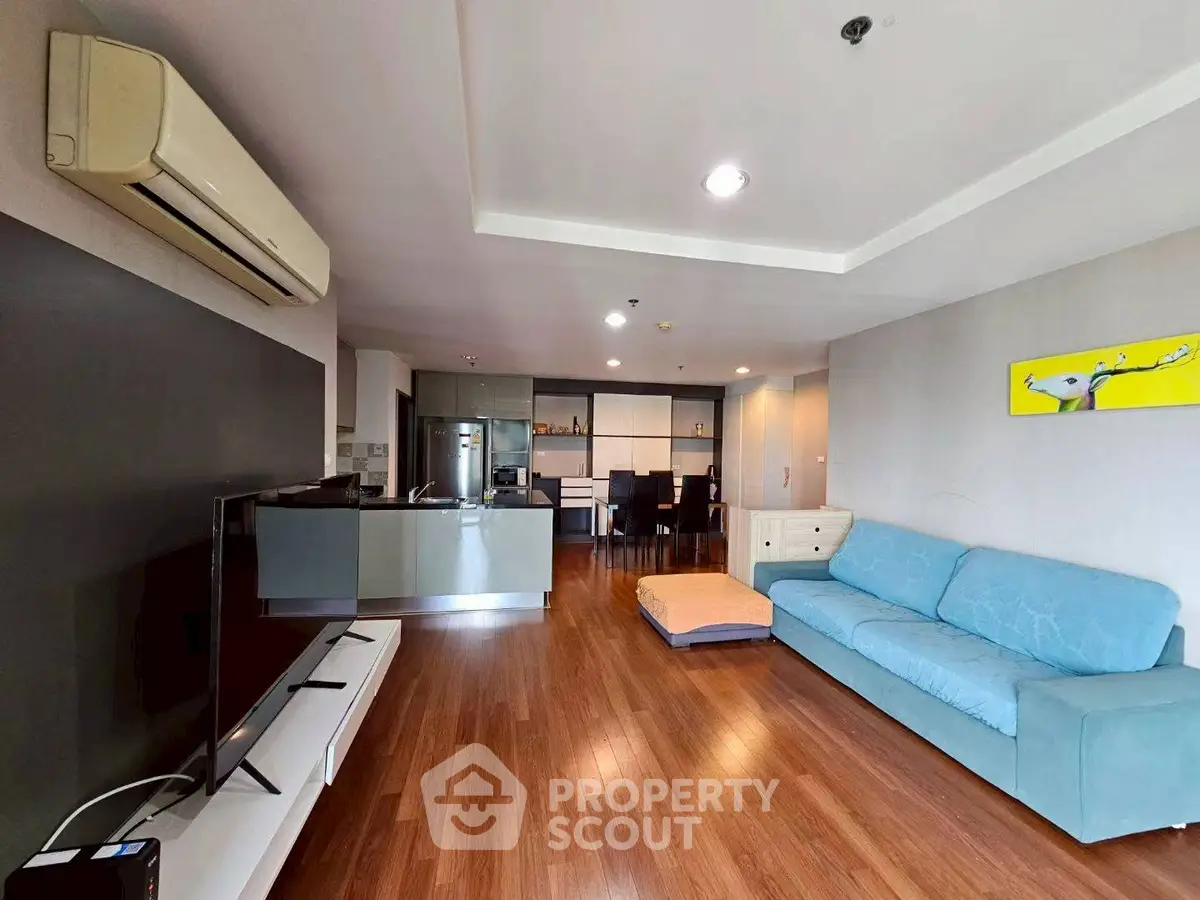 Spacious modern living room with wooden flooring and stylish furniture
