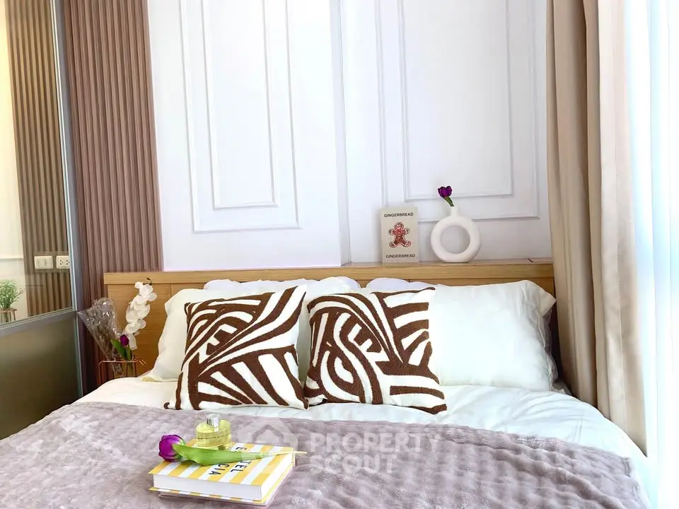 Cozy bedroom with stylish decor and plush bedding in modern apartment