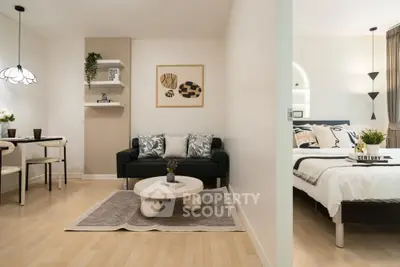 Modern open-plan living room and bedroom with stylish decor and cozy ambiance.