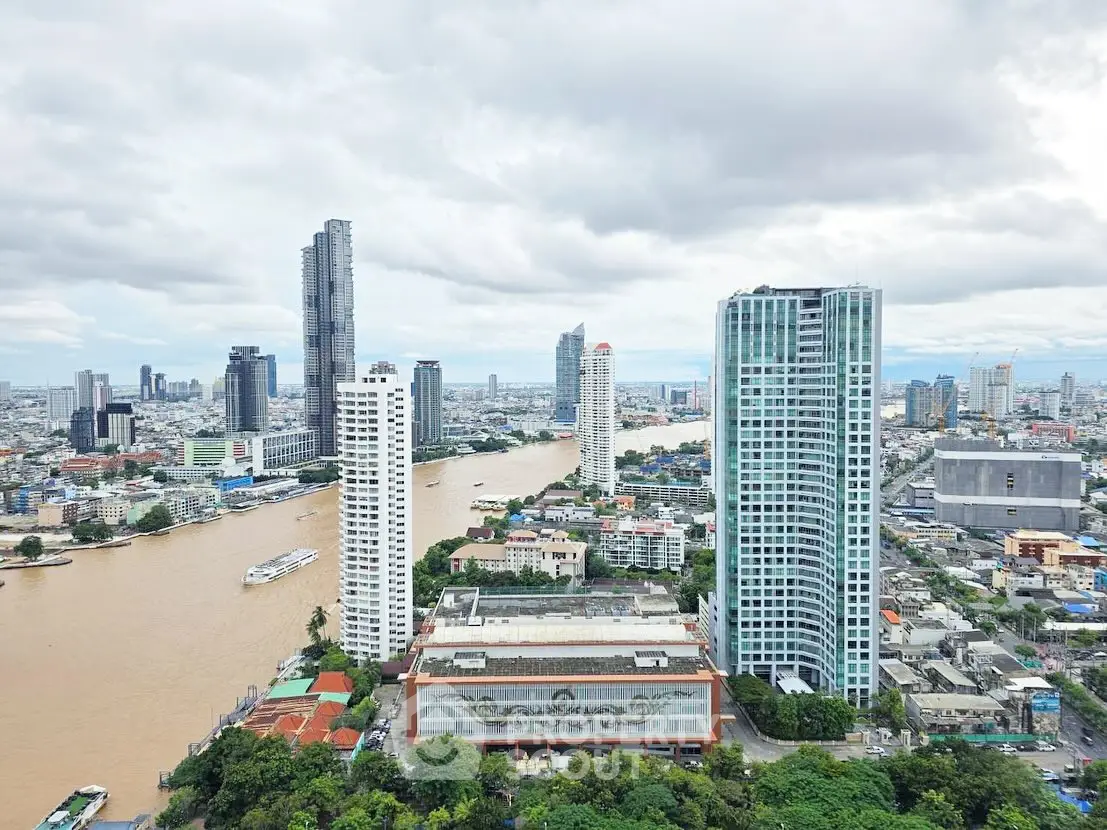 Stunning cityscape view of high-rise buildings along a river, showcasing urban living and architectural beauty.