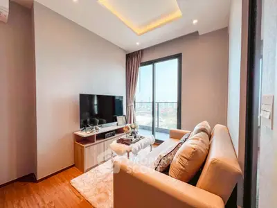 Modern living room with city view, cozy sofa, and sleek TV setup.
