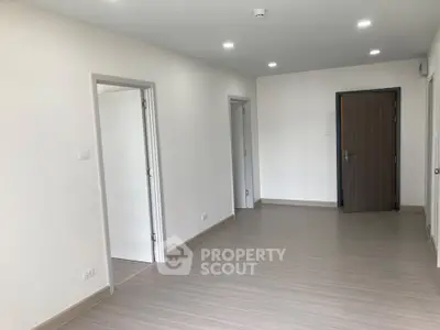 Spacious modern apartment interior with sleek flooring and recessed lighting