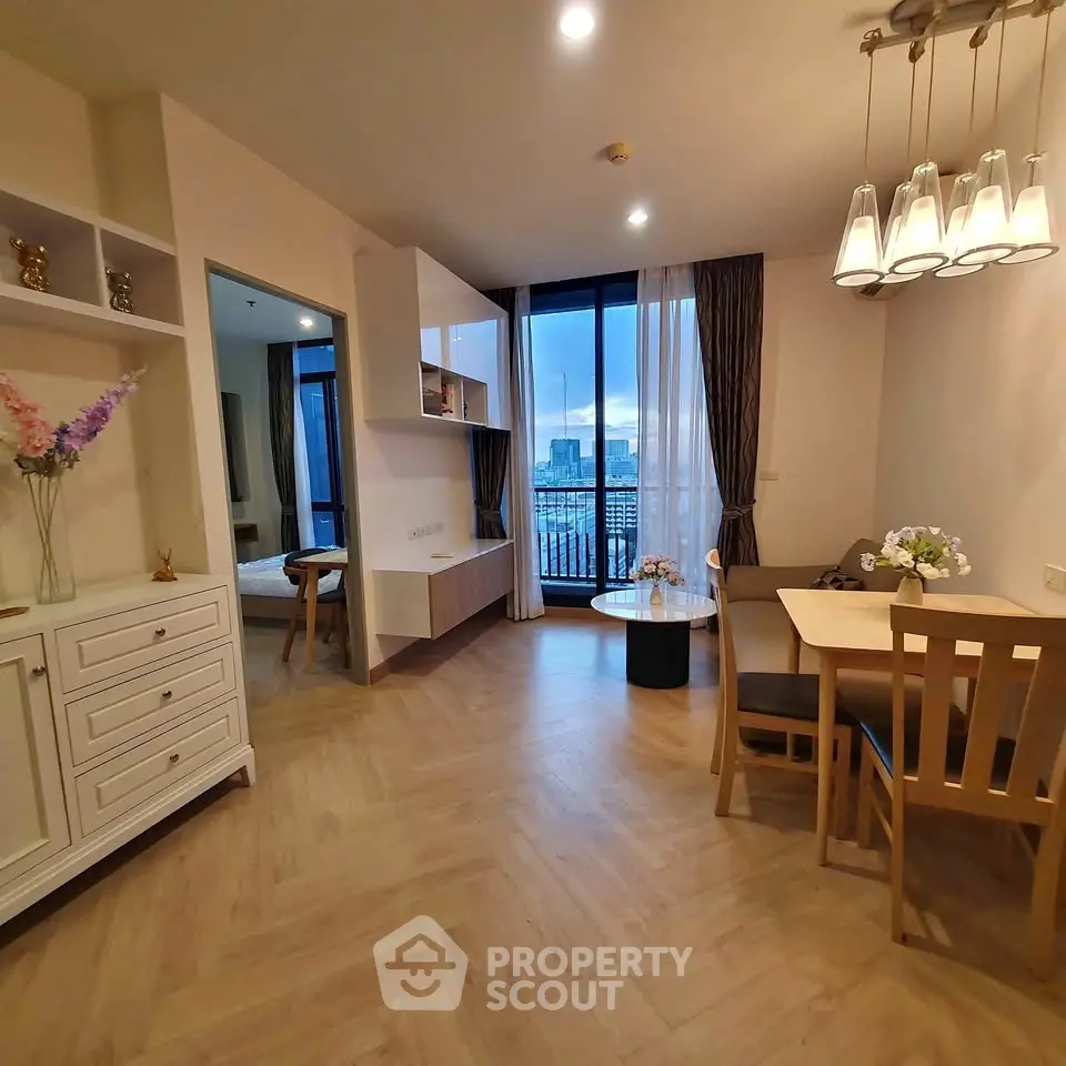 Modern living room with dining area and city view balcony