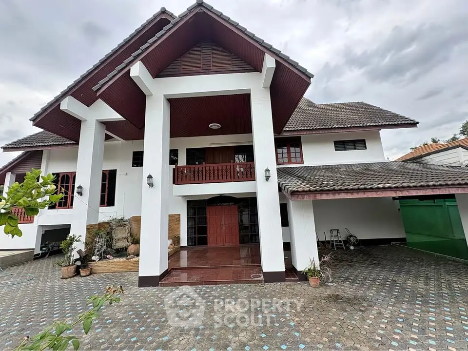 Stunning two-story house with spacious driveway and elegant architectural design.