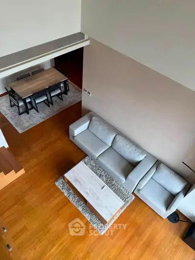 Spacious modern living room with elegant dining area and wooden flooring