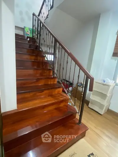 Elegant wooden staircase with metal railing in a modern home interior