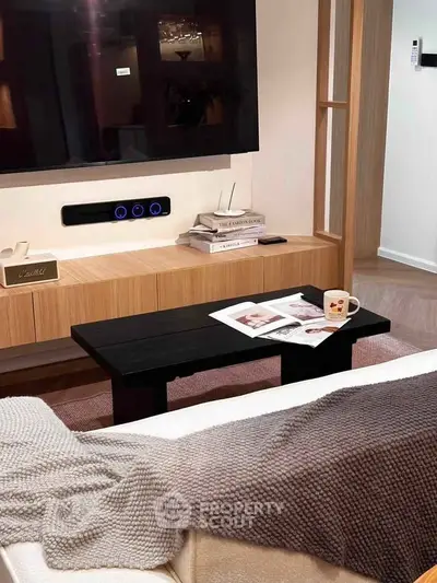 Modern living room with sleek TV setup and cozy decor