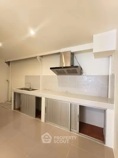 Modern kitchen with sleek design and stainless steel range hood