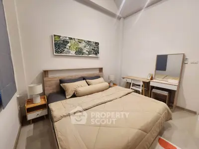 Modern bedroom with stylish decor and cozy ambiance, featuring a comfortable bed and elegant furniture.