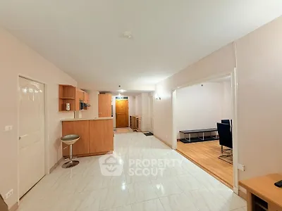 Spacious open-plan living area with modern kitchen and stylish flooring.