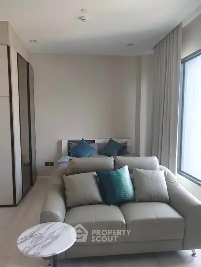 Modern studio apartment with cozy living area and stylish decor.