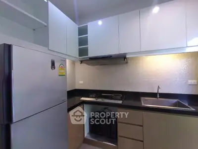 Modern kitchen with sleek cabinets and gas stove in a compact layout.
