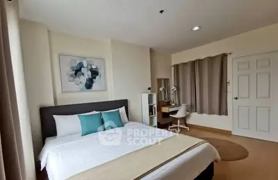 Spacious bedroom with modern decor and study area, perfect for comfort and productivity.