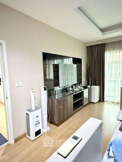 Modern living room with stylish TV unit and natural light